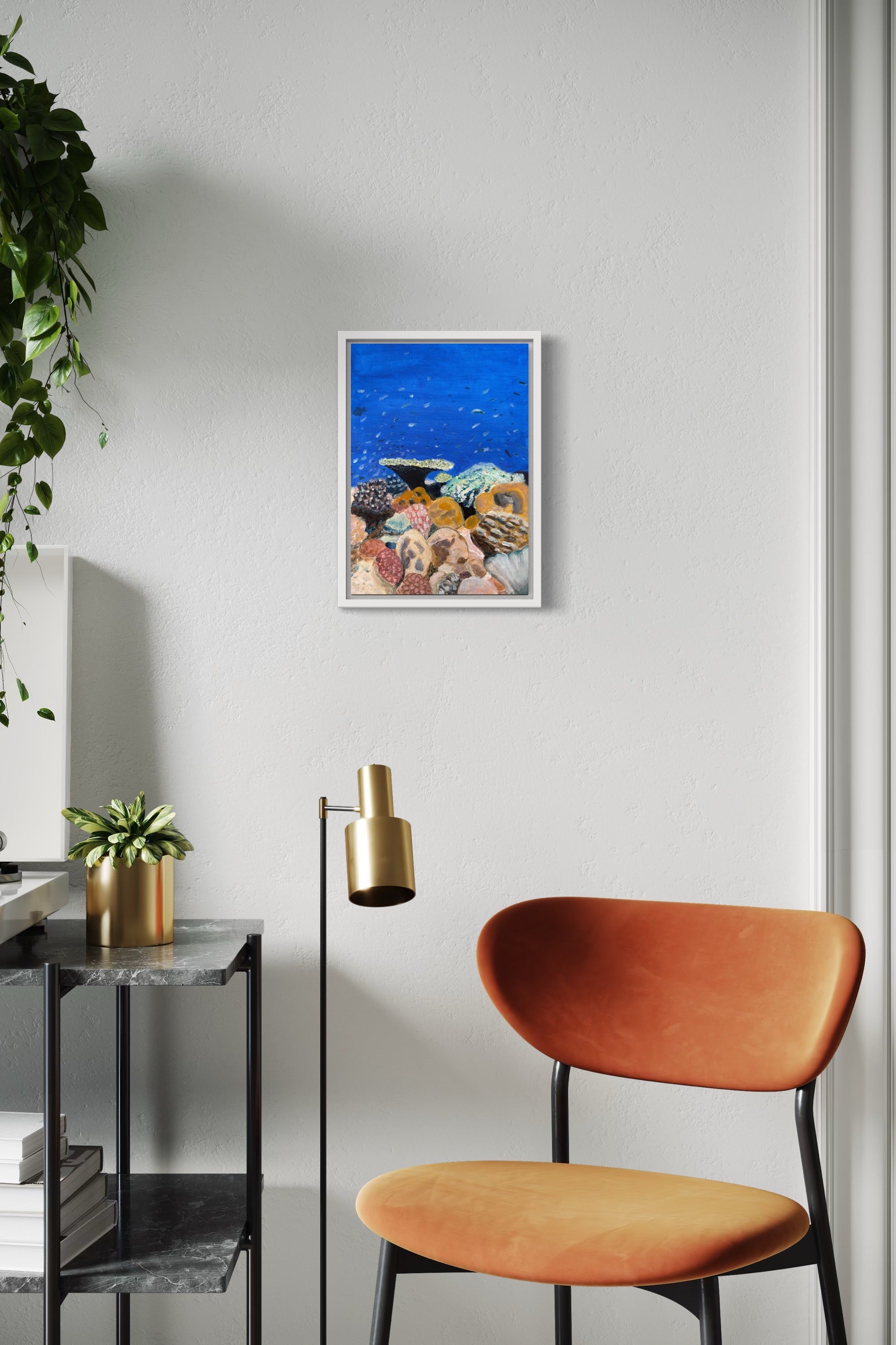 Coral reef I original painting framed in white hanging on wall